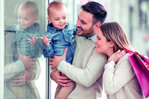 Young family going shopping and looking very happy.